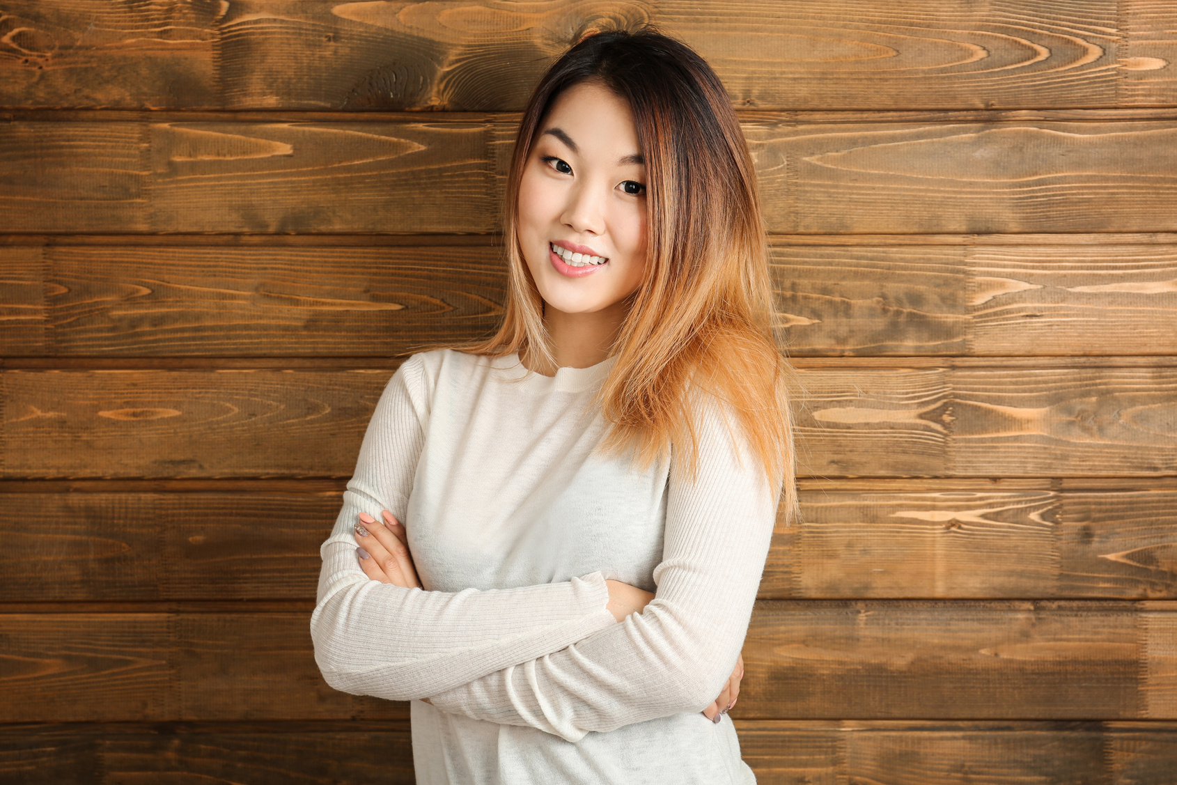 Portrait of Beautiful Smiling Woman on Wooden Background